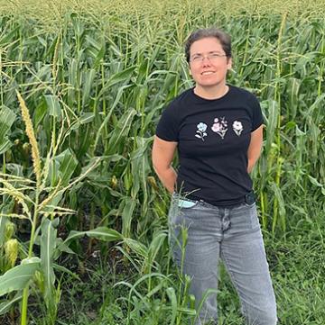 Anna Block standing in a corn field.
