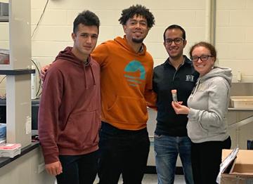 Michelle Heck in a lab with three trainees.