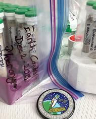 Plastic bags labeled 'Earth Control December 2019 Pheronym' filled with glass tubes containing sand and nematodes.
