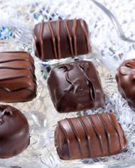 Chocolate candies in a heart-shaped glass dish
